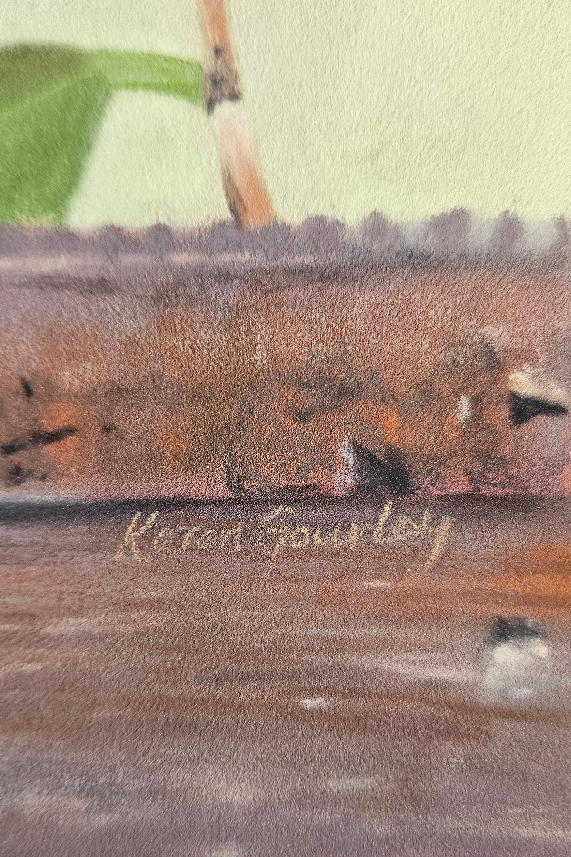 Close-up of a painting with a signature on the bottom right corner.