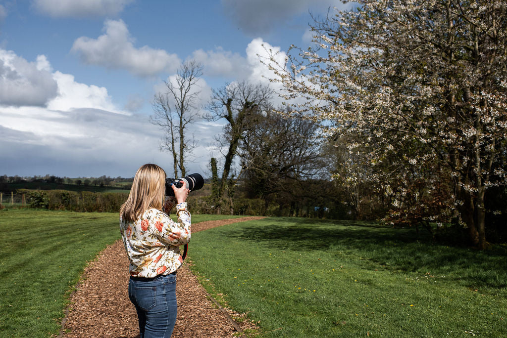 Karen Gourley wildlife artist photographing birds in the countryside with a telephoto lens — gathering reference for her pastel paintings