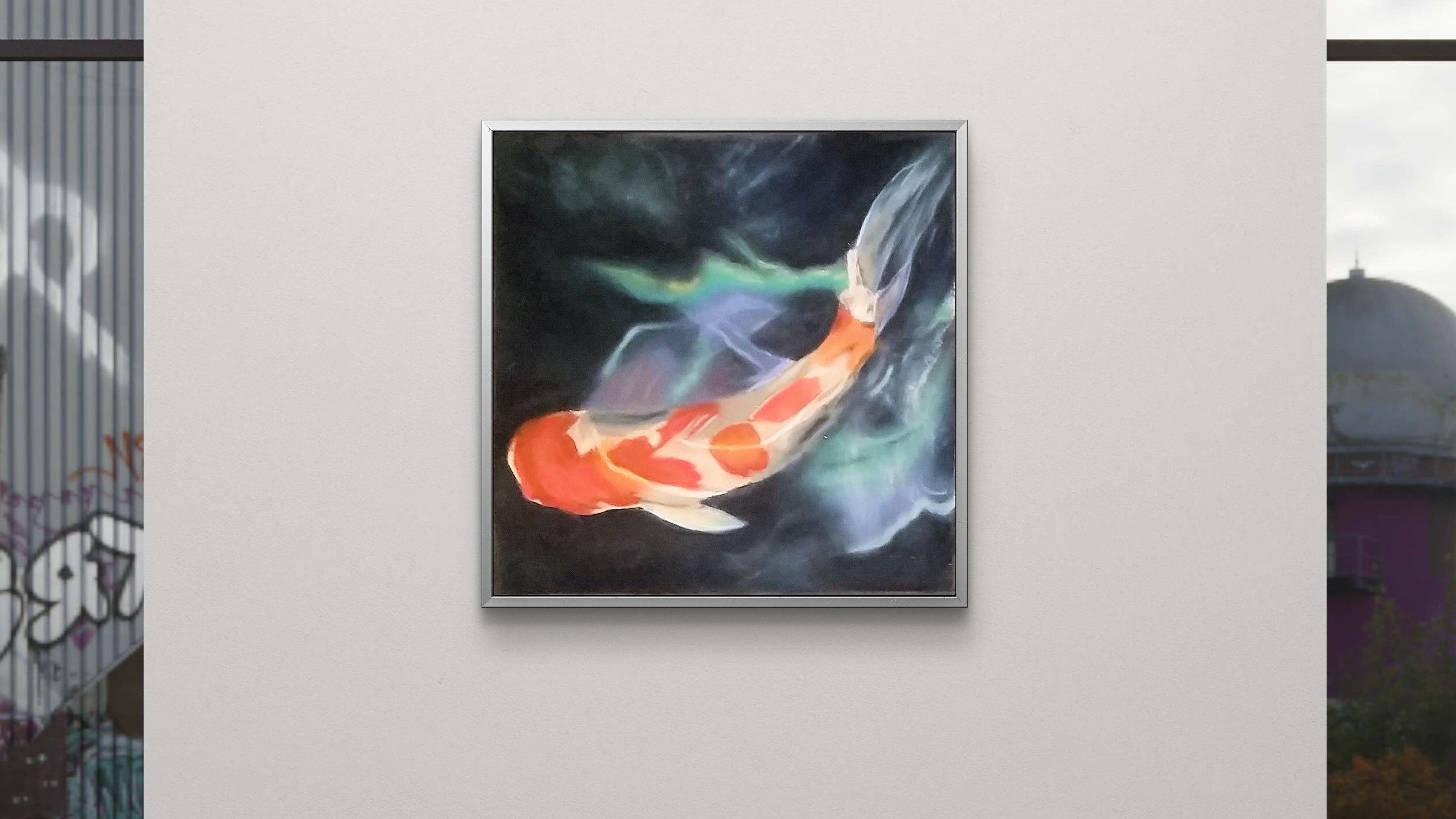 Framed artwork of a colorful fish on a white wall in an indoor setting.
