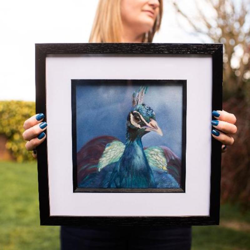 Karen holding Peacock painting