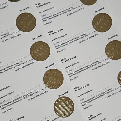 Sheet of gold circular labels with text on a white background