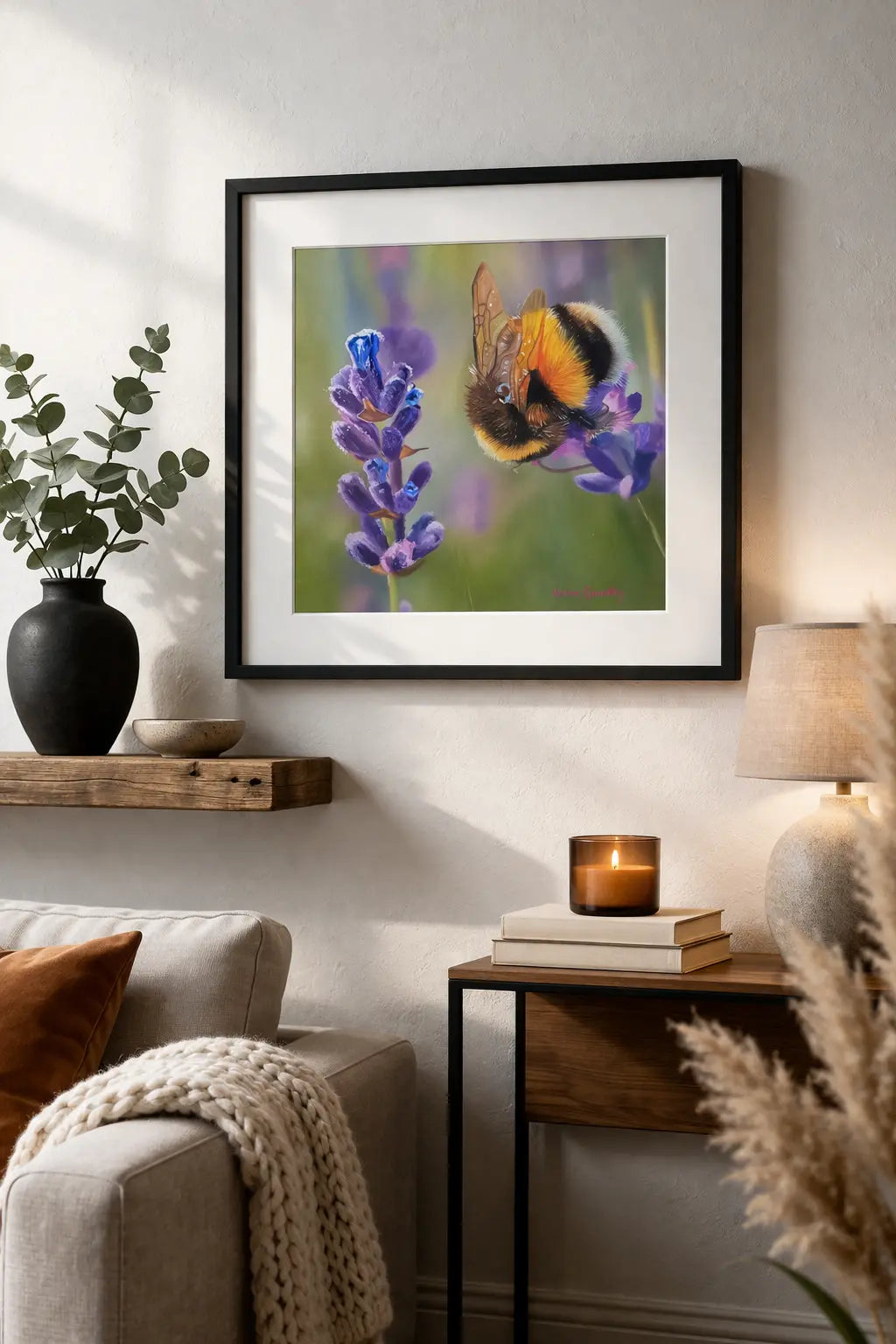 Framed artwork of a bee on a flower in a living room setting.
