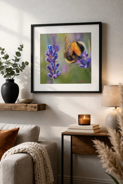 Framed artwork of a bee on a flower in a living room setting.