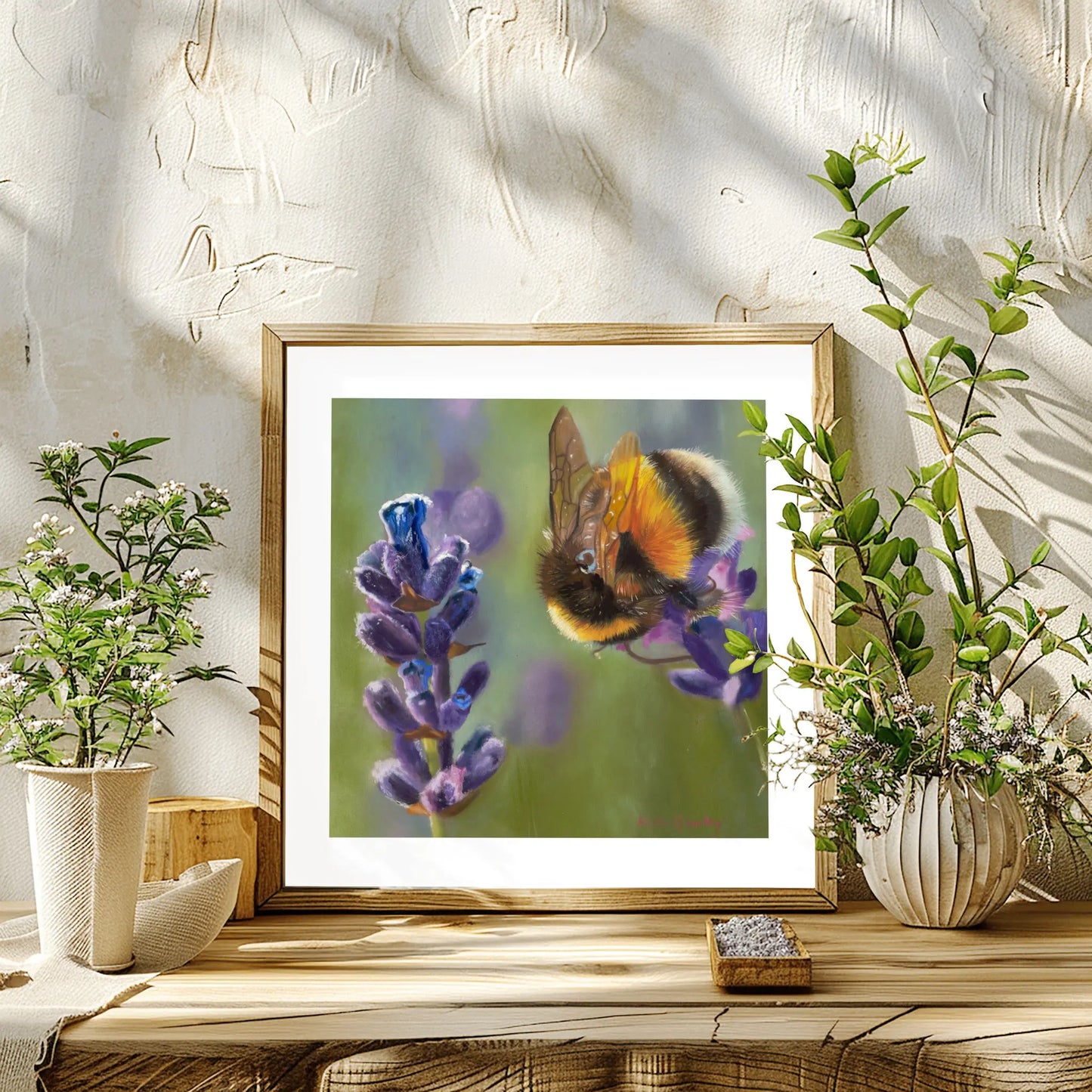 bee and lavender painting framed on a wooden bench