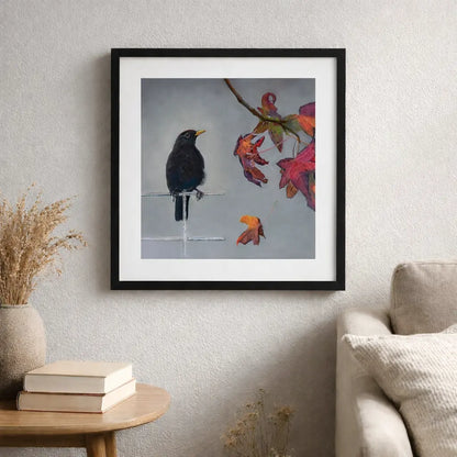Framed artwork of a bird on a branch with autumn leaves in a living room setting.